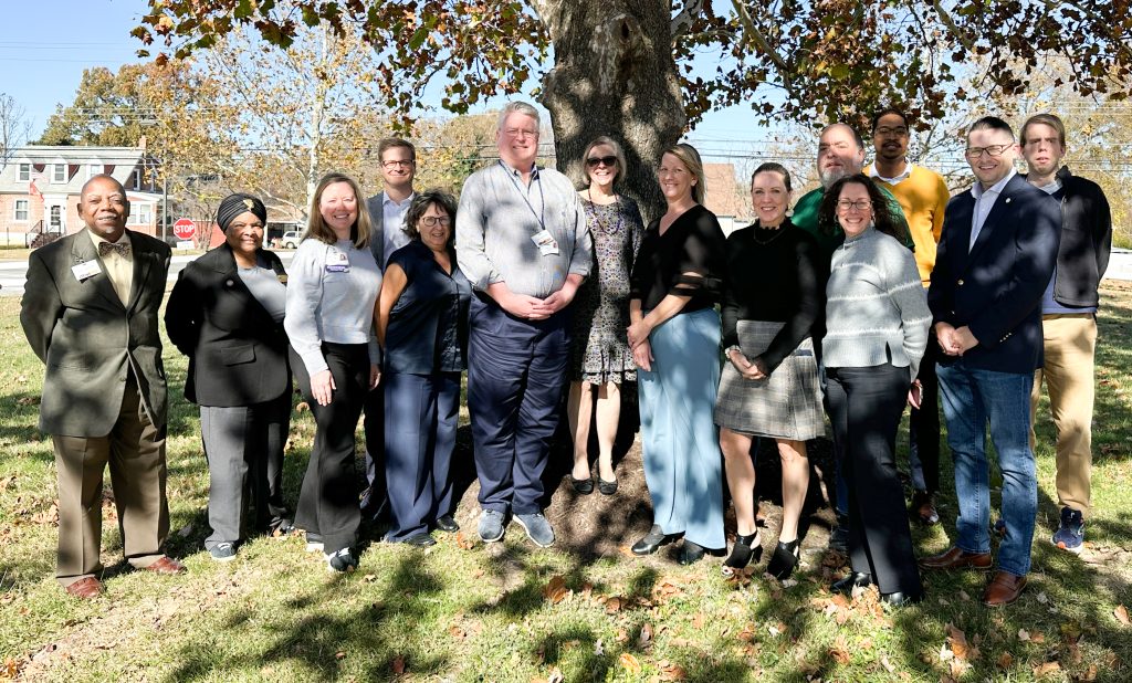 The State Rehabilitation Council members standing outside under a tree on a bright sunny day for a group photo.